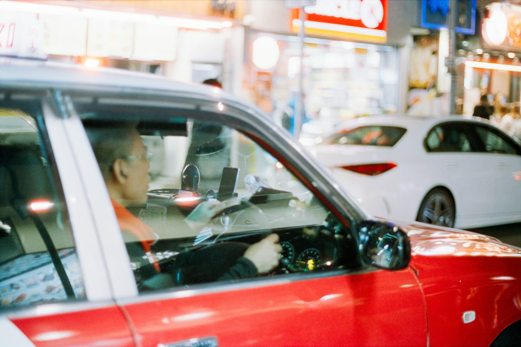 Taxi driving through a city at night